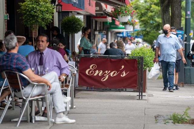 People dining outside of Enzo's in the Bronx